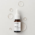Dr.Drop NMN 1% Powder Ampoule — amber glass dropper bottle with a white cap on a light grey surface